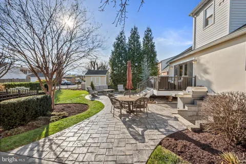 a view of a house with backyard sitting area and garden