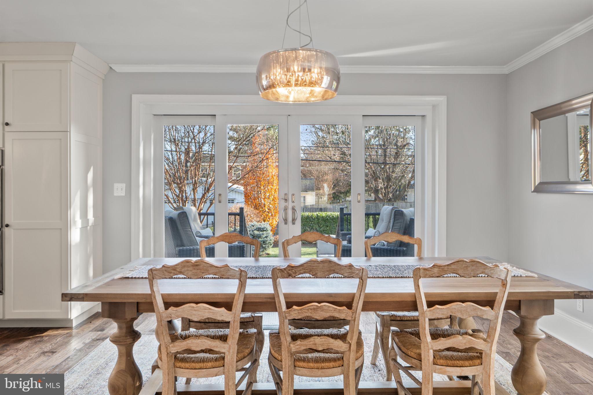 706 Fairview Avenue Frederick, MD 21701 - Photo 10 of 48 a view of a dining room with furniture wooden floor and a chandelier