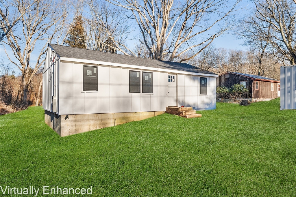 35 Water Street Berkley, MA 02779 - Photo 3 of 16 a white house with a small yard and trees