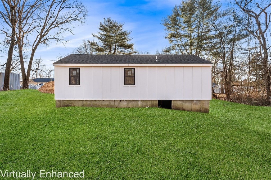 35 Water Street Berkley, MA 02779 - Photo 4 of 16 a front view of house with yard and trees in the background