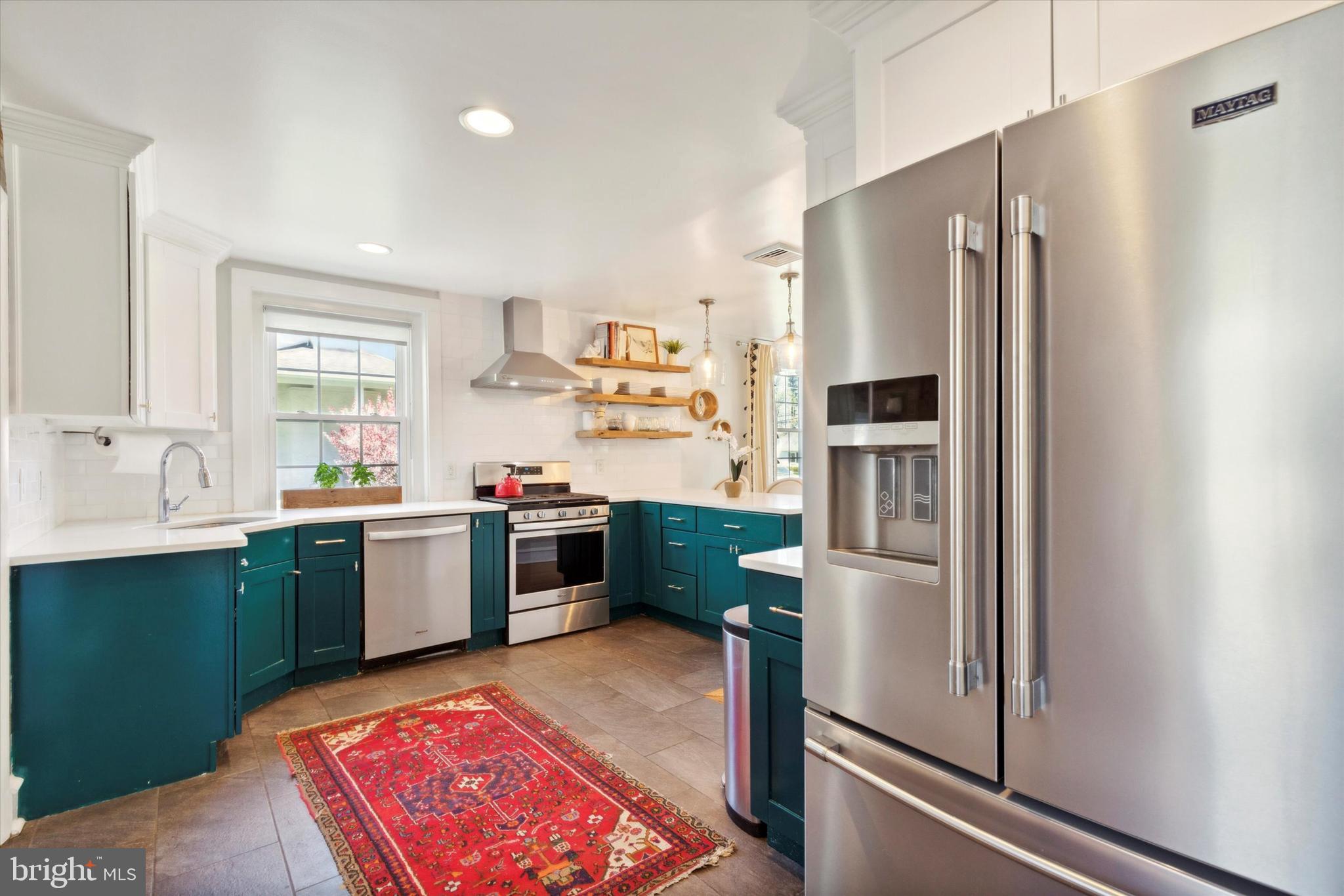 403 Old Lancaster Road Berwyn, PA 19312 - Photo 15 of 41 a kitchen with a refrigerator sink and stainless steel appliances