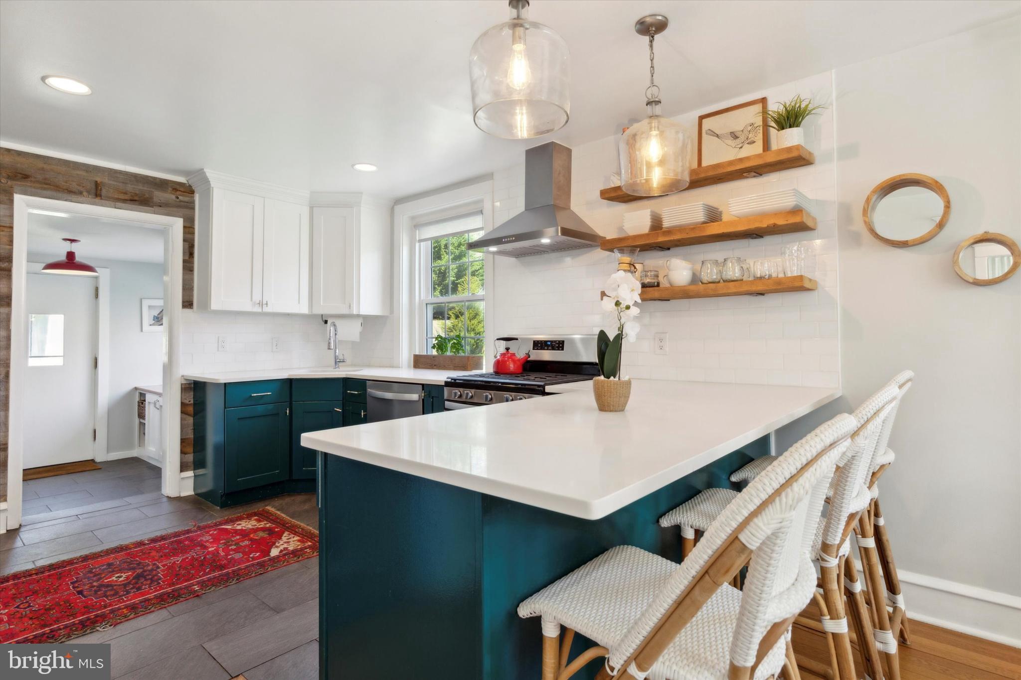 403 Old Lancaster Road Berwyn, PA 19312 - Photo 16 of 41 a kitchen with a table chairs and a chandelier