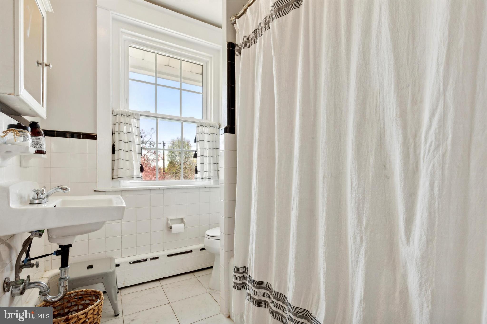 403 Old Lancaster Road Berwyn, PA 19312 - Photo 26 of 41 a bathroom with a sink and a mirror