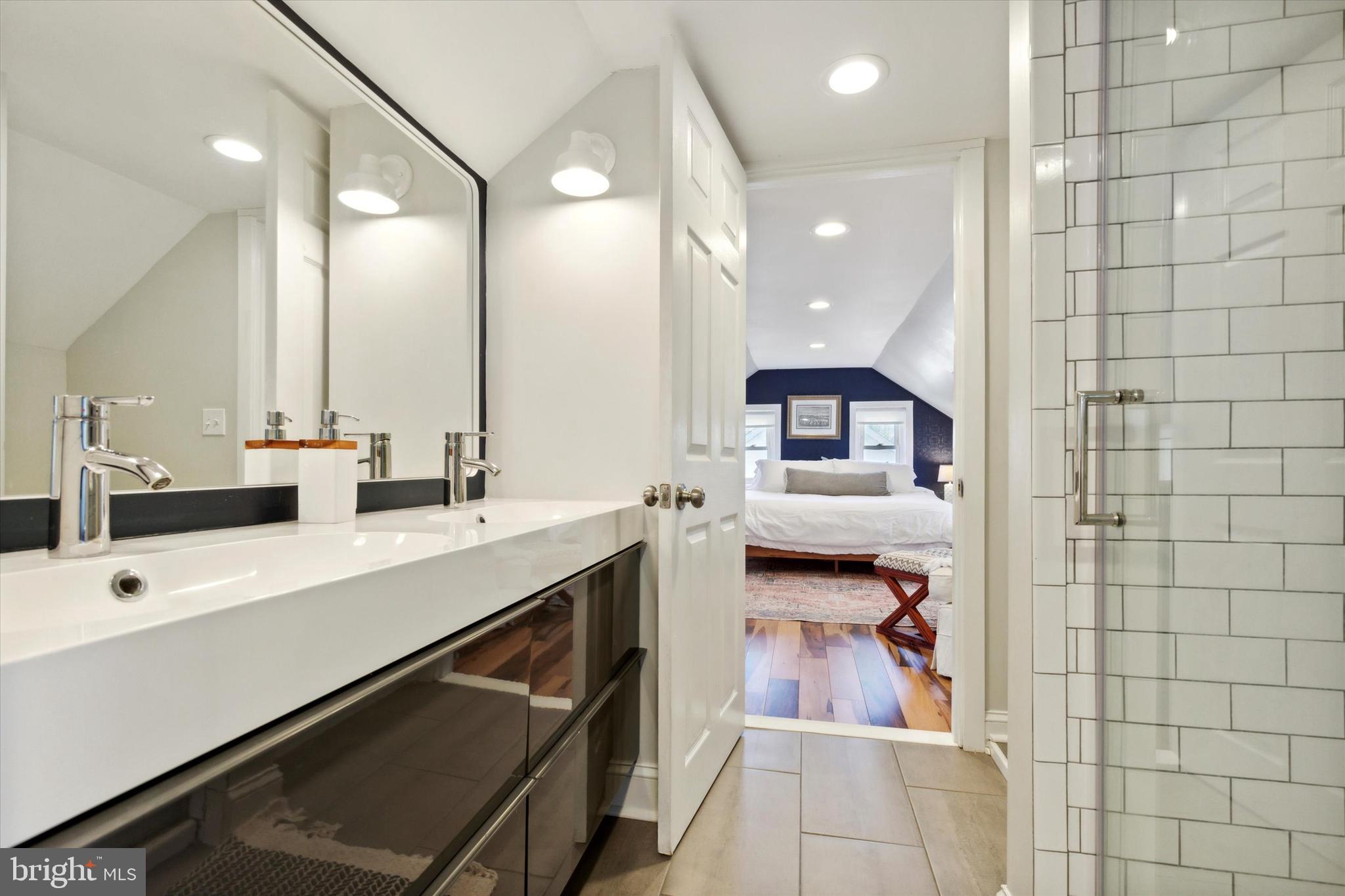 403 Old Lancaster Road Berwyn, PA 19312 - Photo 30 of 41 a en suite bathroom with a double vanity sink a large mirror and shower