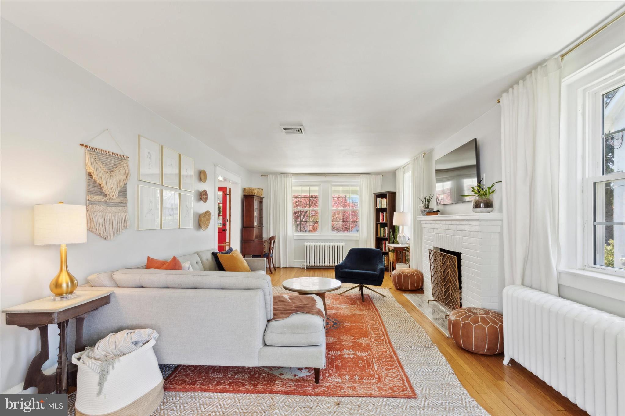 403 Old Lancaster Road Berwyn, PA 19312 - Photo 10 of 41 a living room with furniture a fireplace and a flat screen tv