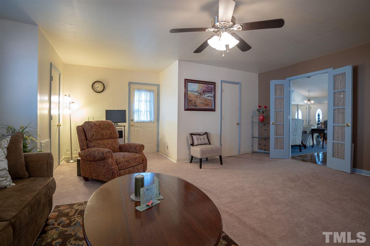 3411 Freeman Road Durham, NC 27703 - Photo 13 of 24 a living room with furniture and a chandelier