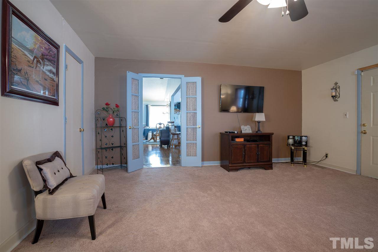 3411 Freeman Road Durham, NC 27703 - Photo 14 of 24 a living room with furniture and a flat screen tv
