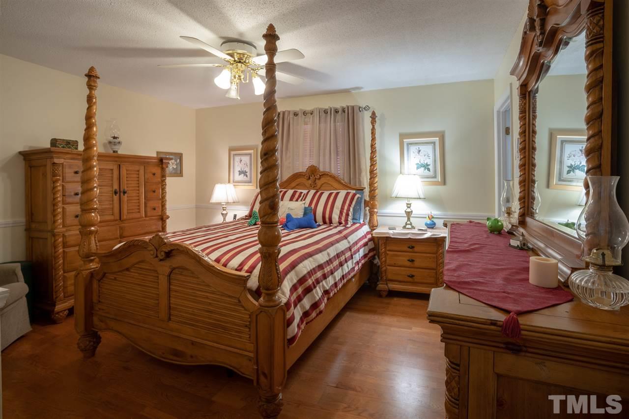 3411 Freeman Road Durham, NC 27703 - Photo 15 of 24 a bedroom with a bed and wooden floor