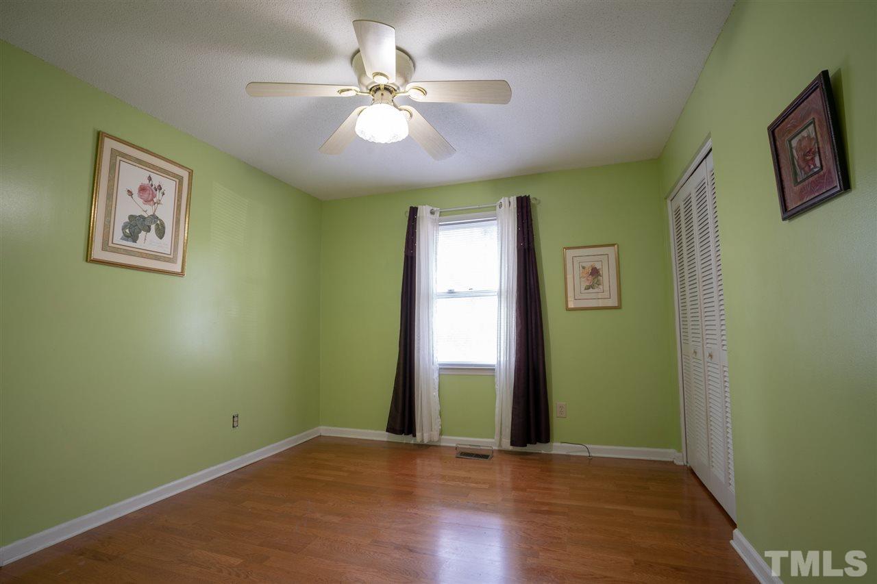 3411 Freeman Road Durham, NC 27703 - Photo 20 of 24 a view of an empty room with window and wooden floor