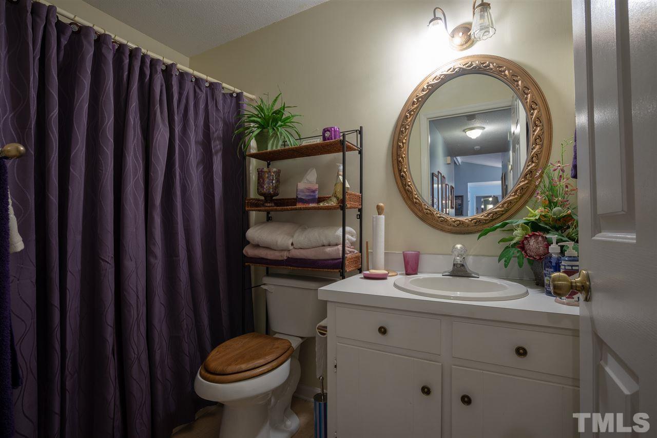 3411 Freeman Road Durham, NC 27703 - Photo 21 of 24 a bathroom with a toilet sink vanity mirror and vanity