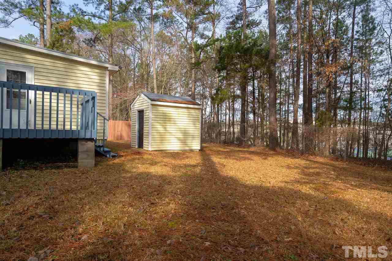 3411 Freeman Road Durham, NC 27703 - Photo 23 of 24 a view of a house with a backyard and a tree