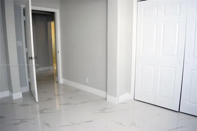 an empty room with windows and entrance