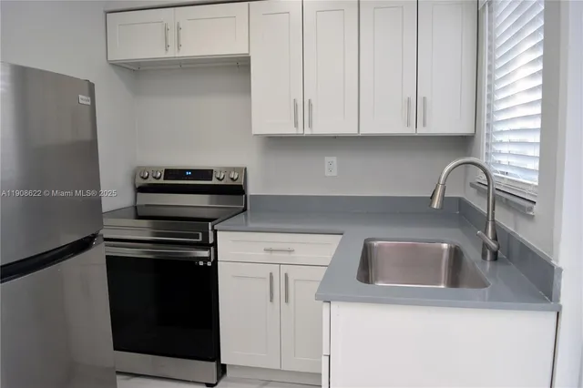 a kitchen with a sink and cabinets