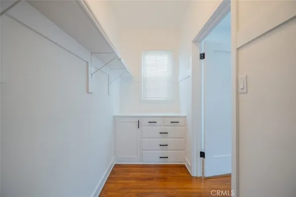 a view of walk in closet with empty racks