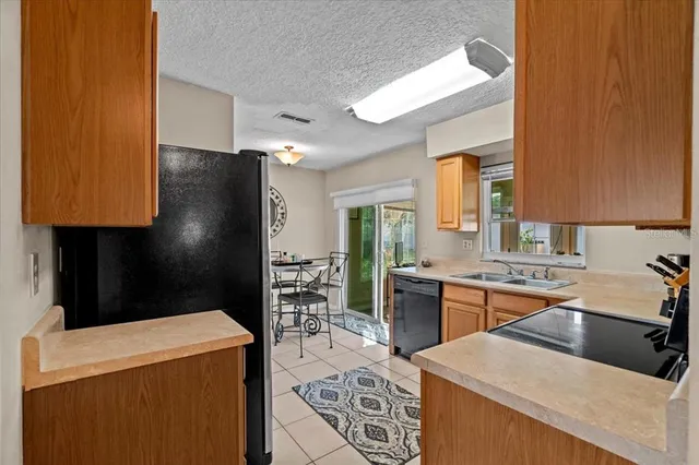 a kitchen with a sink a stove and refrigerator