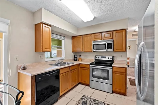 a kitchen with a sink stove and stainless steel appliances