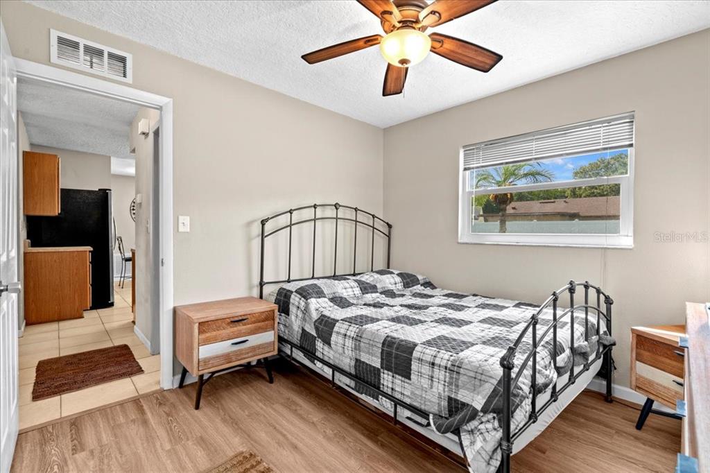 7041 Daggett Terrace New Port Richey, FL 34655 - Photo 16 of 29 a bedroom with a bed and a chandelier