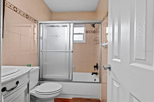 a bathroom with a shower a toilet and a sink