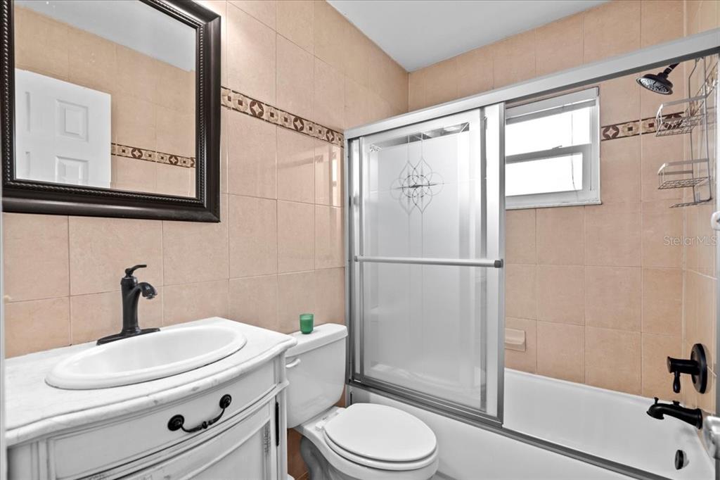 7041 Daggett Terrace New Port Richey, FL 34655 - Photo 19 of 29 a bathroom with a toilet a sink and a shower