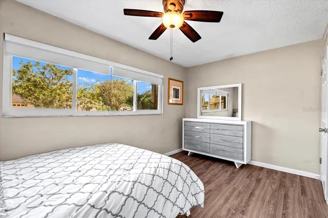 a bedroom with bed and wooden floor