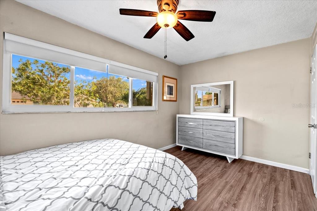 7041 Daggett Terrace New Port Richey, FL 34655 - Photo 21 of 29 a bedroom with bed and wooden floor