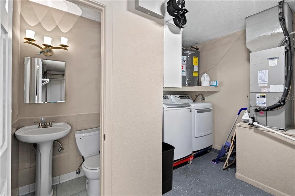 7041 Daggett Terrace New Port Richey, FL 34655 - Photo 27 of 29 a bathroom with a sink toilet and a mirror
