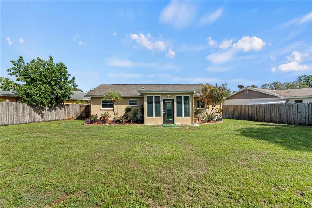 7041 Daggett Terrace New Port Richey, FL 34655 - Photo 7 of 29 a front view of a house with a garden
