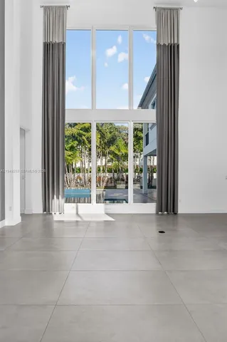 a view of a kitchen with a sink and white cabinets