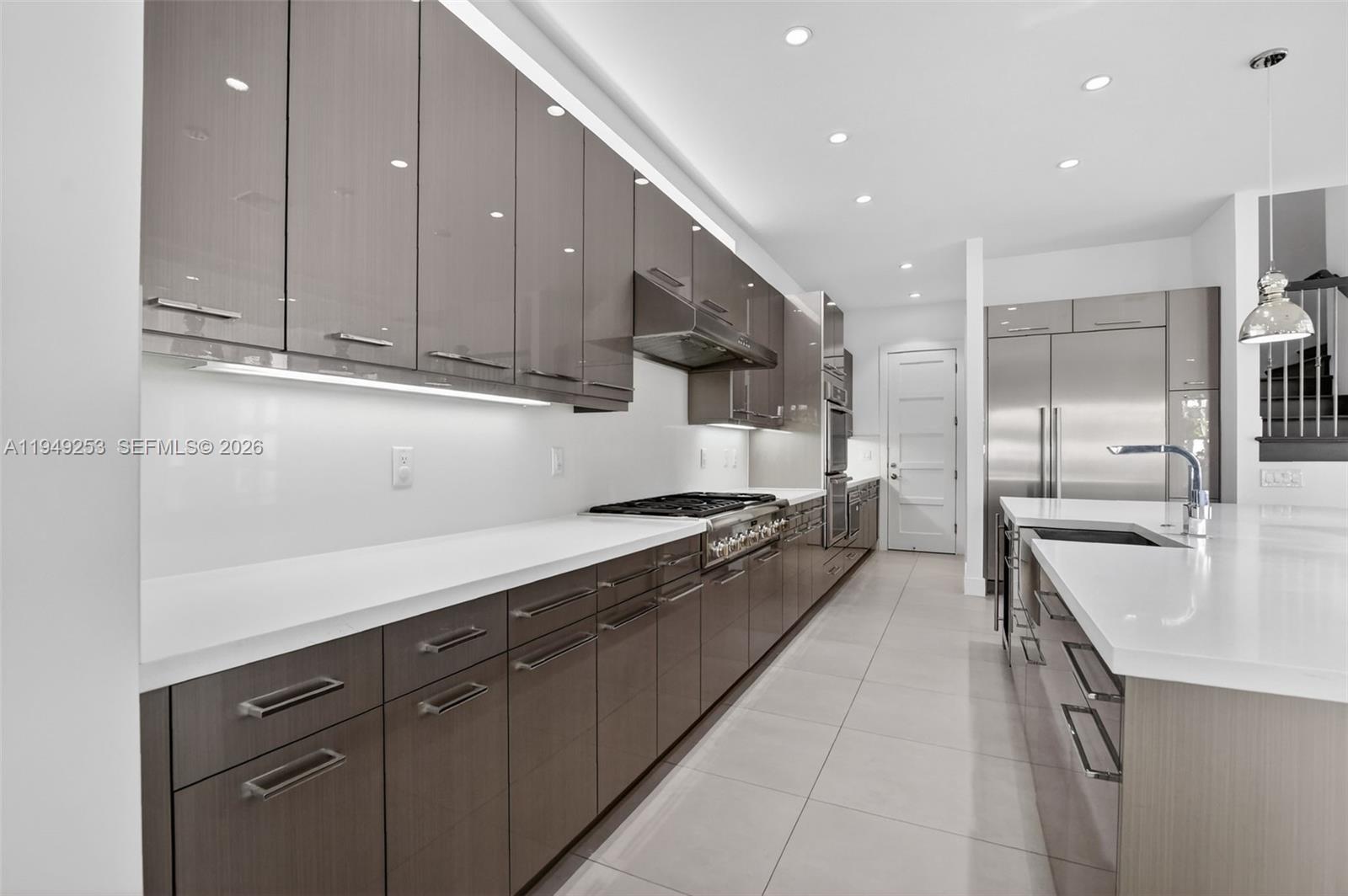 201 Northeast 6th Street Boca Raton, FL 33432 - Photo 21 of 100 a large kitchen with stainless steel appliances granite countertop a sink a stove and a refrigerator