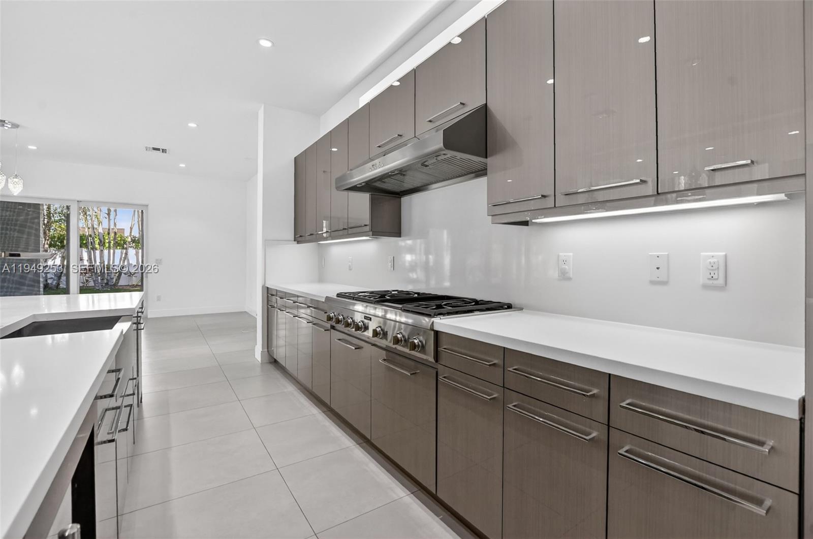 201 Northeast 6th Street Boca Raton, FL 33432 - Photo 23 of 100 a kitchen with stainless steel appliances granite countertop a sink and a stove