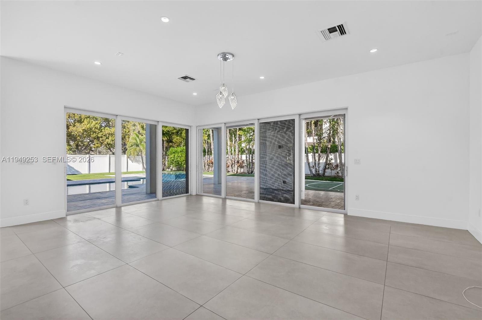 201 Northeast 6th Street Boca Raton, FL 33432 - Photo 25 of 100 a view of an empty room with a sliding door and windows