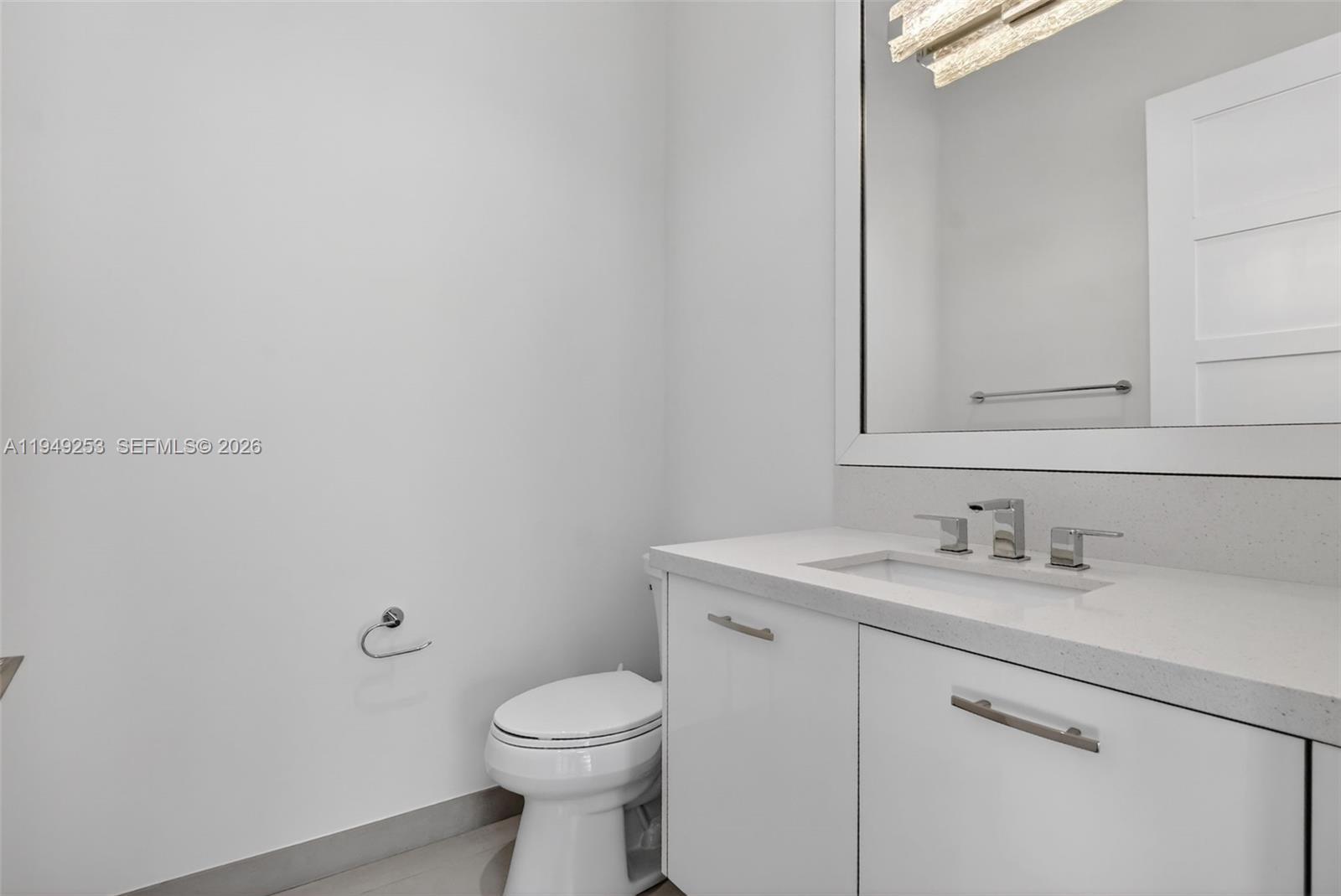 201 Northeast 6th Street Boca Raton, FL 33432 - Photo 28 of 100 a bathroom with a sink and a toilet