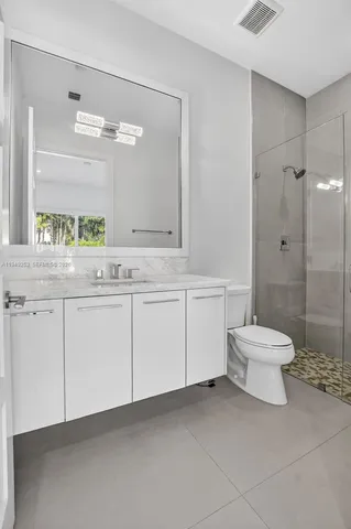 a bathroom with a shower and a toilet