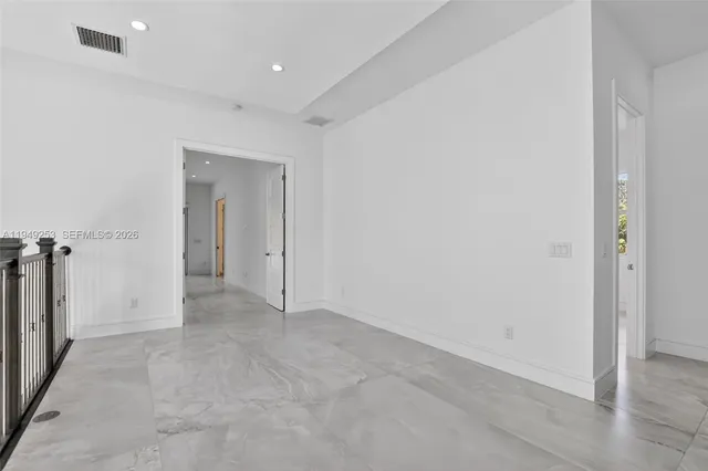 an aerial view of a house with a garden and lake view