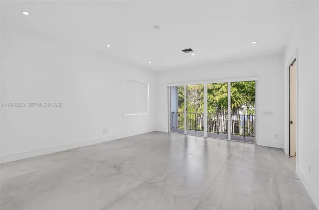an aerial view of residential houses with city and green space
