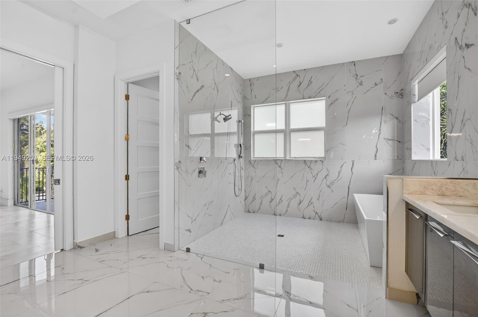 201 Northeast 6th Street Boca Raton, FL 33432 - Photo 51 of 100 a bathroom with a tub sink and glass door shower