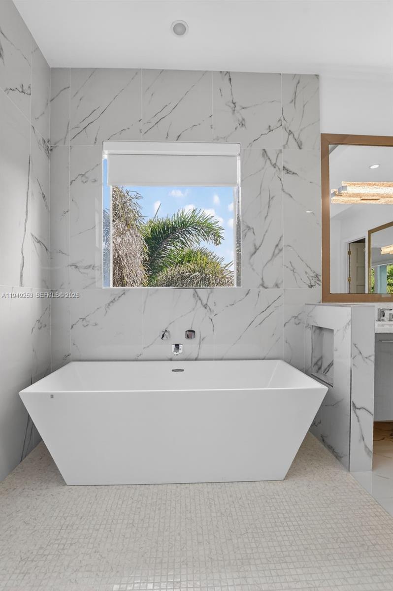 201 Northeast 6th Street Boca Raton, FL 33432 - Photo 53 of 100 a white bath tub sitting in a bathroom