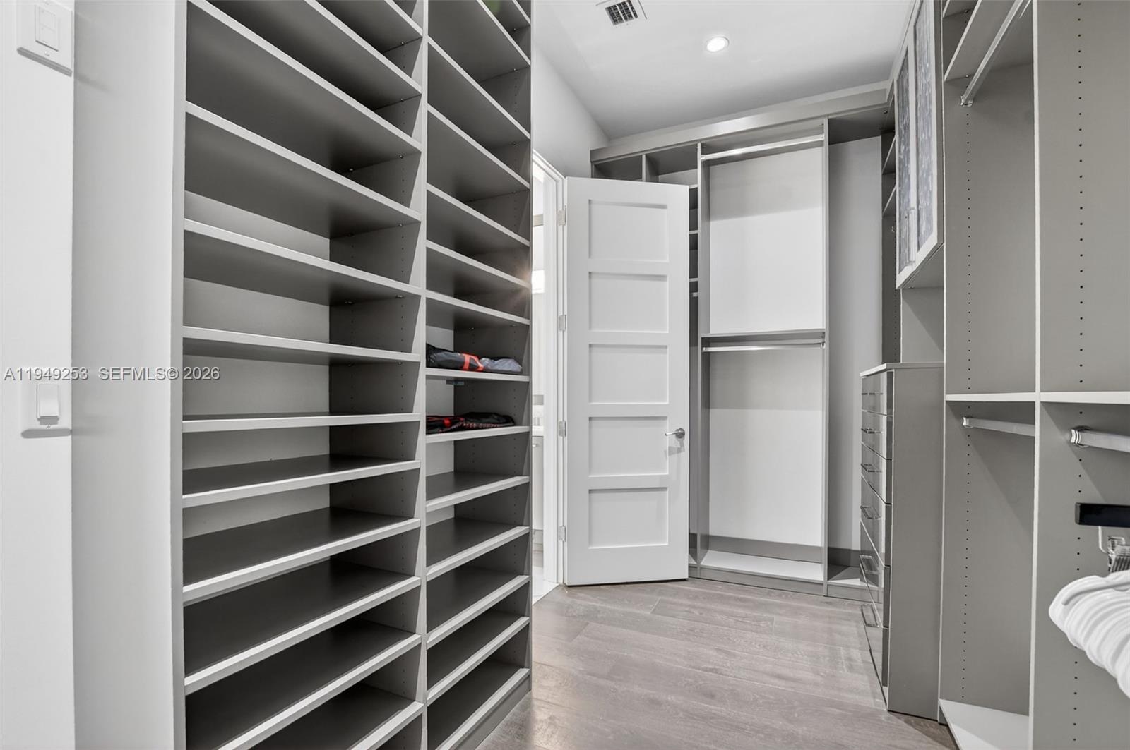 201 Northeast 6th Street Boca Raton, FL 33432 - Photo 55 of 100 a view of walk in closet with empty racks