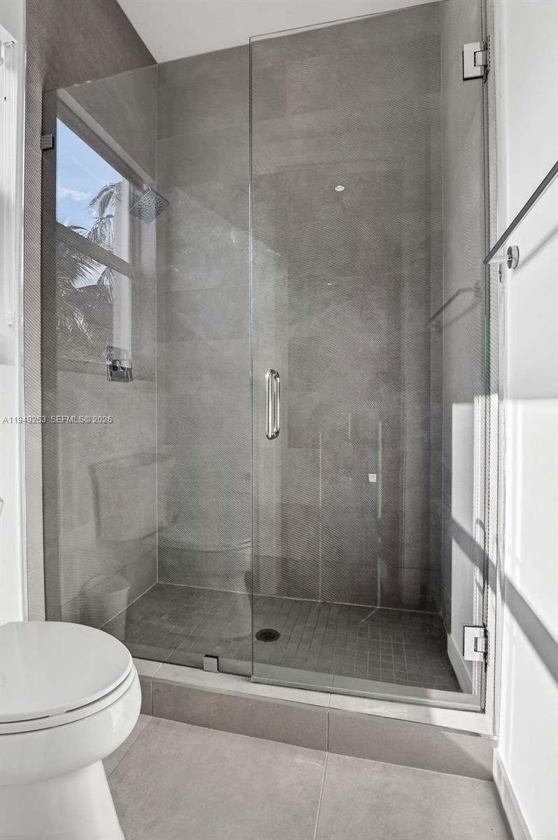 201 Northeast 6th Street Boca Raton, FL 33432 - Photo 67 of 100 a bathroom with a shower and a toilet