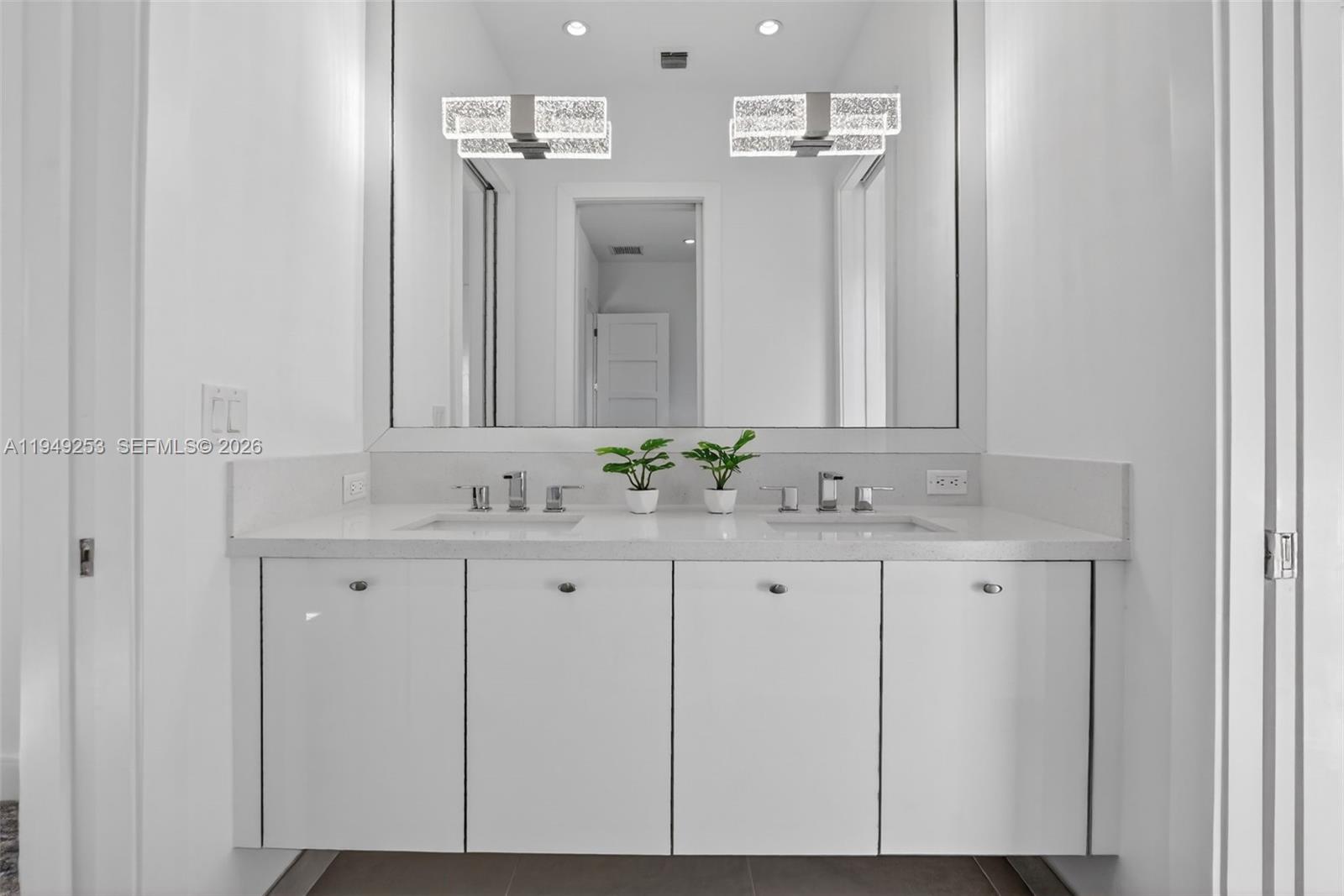 201 Northeast 6th Street Boca Raton, FL 33432 - Photo 68 of 100 a bathroom with a sink and a mirror