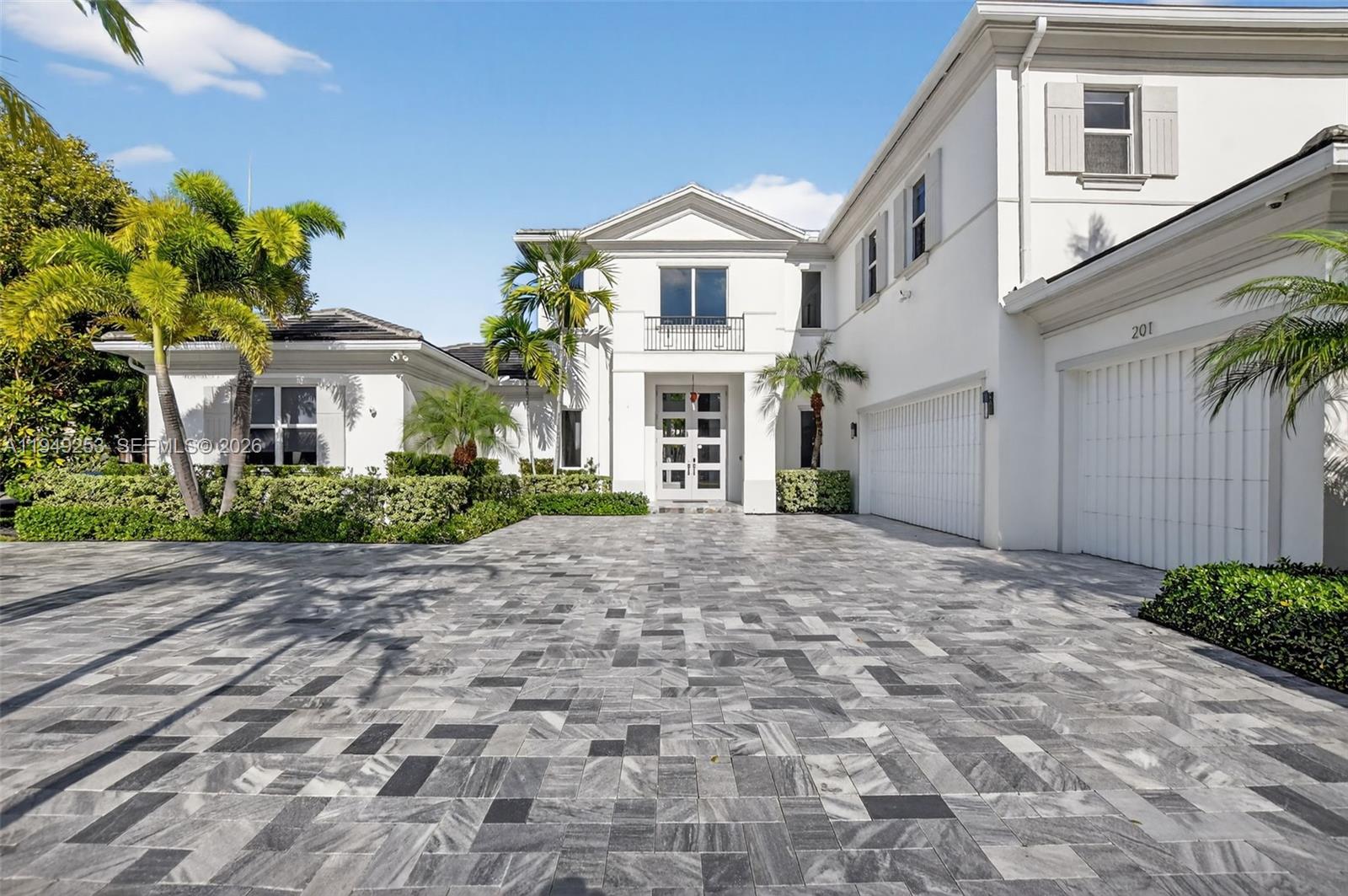 201 Northeast 6th Street Boca Raton, FL 33432 - Photo 71 of 100 a front view of a house with a yard and a garage
