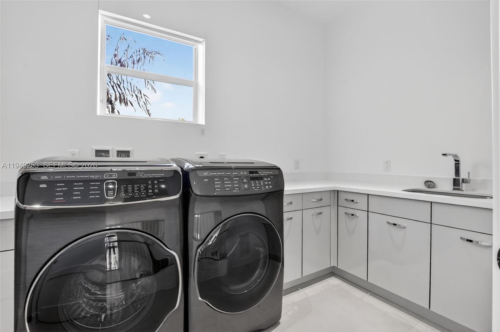 201 Northeast 6th Street Boca Raton, FL 33432 - Photo 9 of 100 a utility room with sink dryer and washer