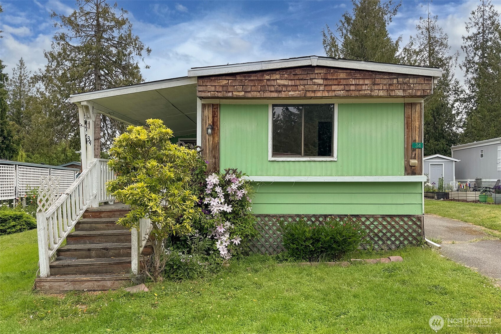 90 Baywood Village Road, Unit 34 Sequim, WA 98382 - Photo 2 of 40 a front view of a house with a yard