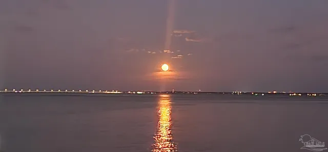 a room with furniture pool table and a floor to ceiling window