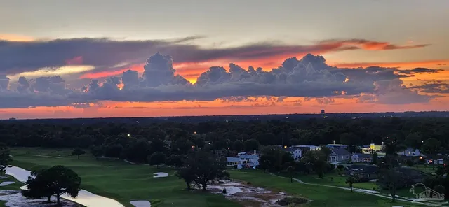 a view of a patio with table and chairs and potted plants