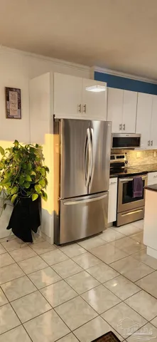a kitchen with stainless steel appliances a refrigerator sink and cabinets