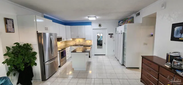 a kitchen with stainless steel appliances a refrigerator and a stove
