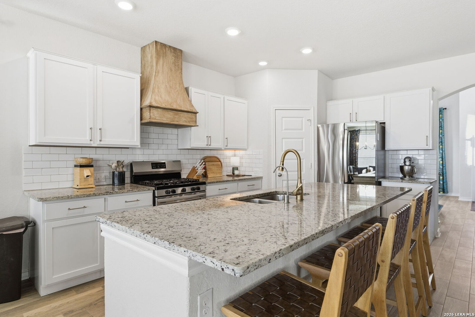 3410 Copper Acres Bulverde, TX 78163 - Photo 13 of 50 a kitchen with stainless steel appliances granite countertop a kitchen island a stove a sink a refrigerator and cabinets