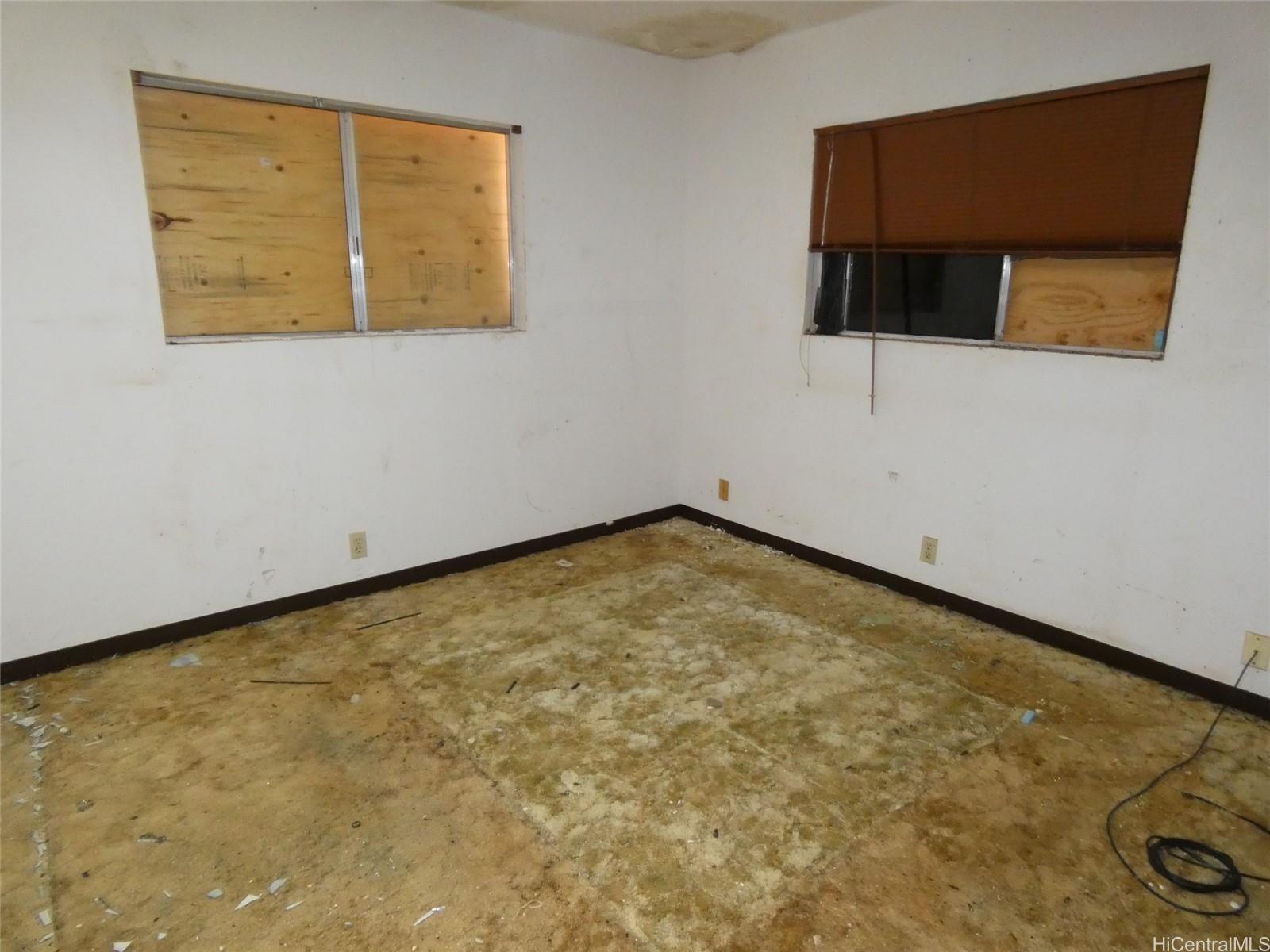 94-605 Kupuna Loop Waipahu, HI 96797 - Photo 6 of 12 a view of a room with a wooden floor and a window
