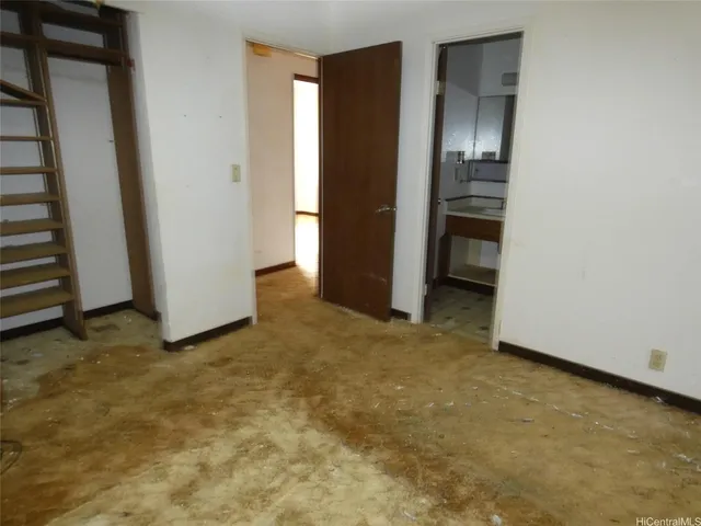 an empty room with closet and mirrors